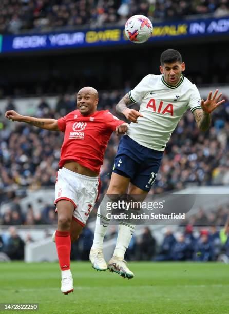 Andre Ayew of Nottingham Forest and Cristian Romero of Tottenham Hotspur compete for the ball during the Premier League match between Tottenham...