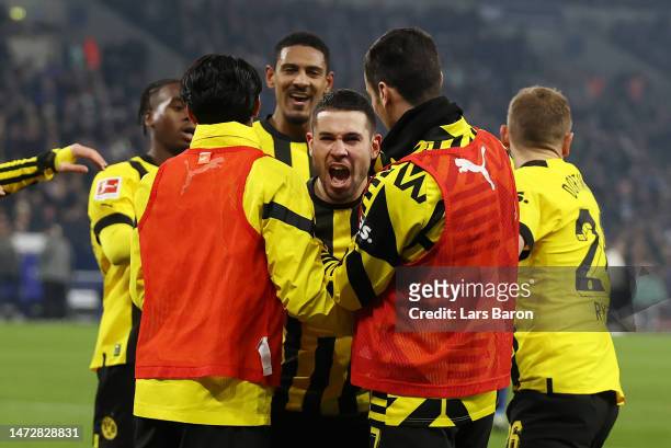 Raphael Guerreiro of Borussia Dortmund celebrates after scoring the team's second goal during the Bundesliga match between FC Schalke 04 and Borussia...
