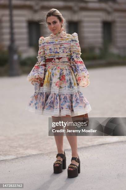 Fashion week guest is seen wearing a brown leather Hermes Kelly bag, a colourful mini dress and brown plateau shoes before the Zimmermann show on...