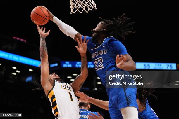 Terrence Hargrove Jr. #22 of the Saint Louis Billikens blocks a shot by Adrian Baldwin Jr. #1 of the Virginia Commonwealth Rams in the second half...