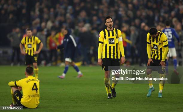 Nico Schlotterbeck, Mats Hummels and Emre Can of Borussia Dortmund look dejected following the Bundesliga match between FC Schalke 04 and Borussia...