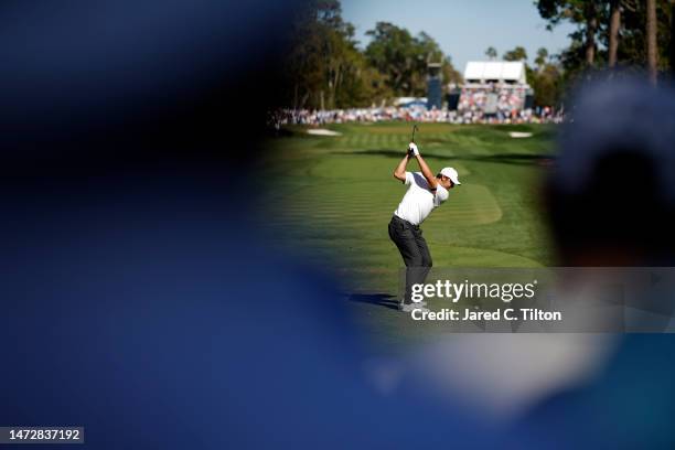 Scottie Scheffler of the United States plays his shot from the eighth tee as fans look on during the third round of THE PLAYERS Championship on THE...