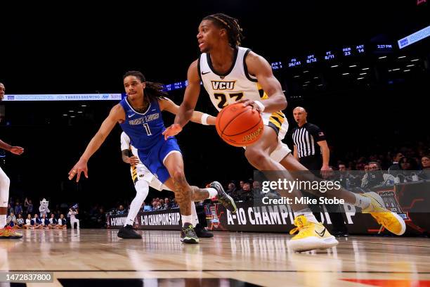 Jayden Nunn of the Virginia Commonwealth Rams drives to the net Yuri Collins of the Saint Louis Billikens in the second half during the Semifinals of...
