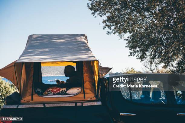 man is resting in a tent in a car. - van turkey stock pictures, royalty-free photos & images