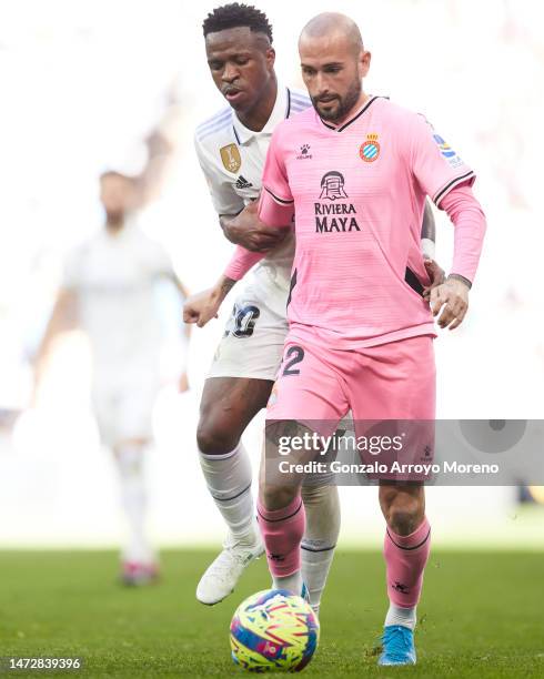 Vinicius Junior of Real Madrid CF competes for the ball with Aleix Vidal of RCD Espanyol during the LaLiga Santander match between Real Madrid CF and...