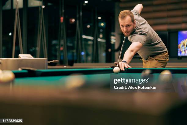 excited, mature man playing billiard. - pool table stock pictures, royalty-free photos & images