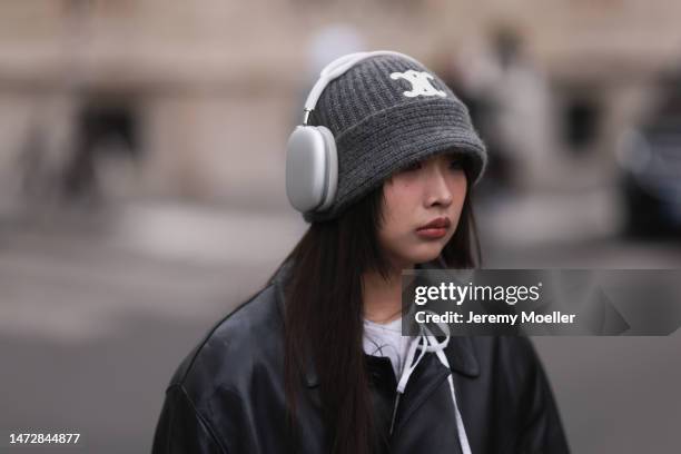 Fashion Week guest is seen wearing a black leather jacket, white shirt, and grey hat outside the Louis Vuitton show during Paris Fashion Week on...