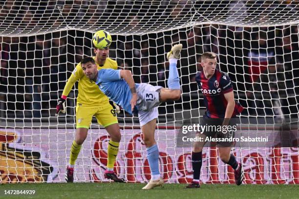 Alessio Romagnoli of SS Lazio clears the ball whilst under pressure from Lewis Ferguson of Bologna FC during the Serie A match between Bologna FC and...
