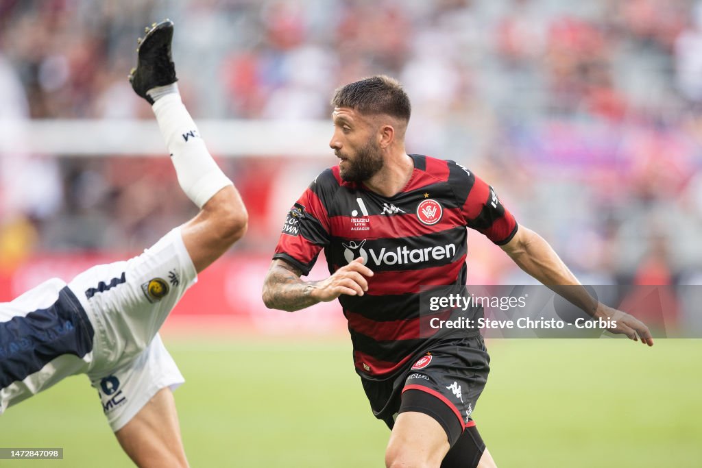 Brandon Borrello of the Wanderers is heavily challenged by Jacob ...