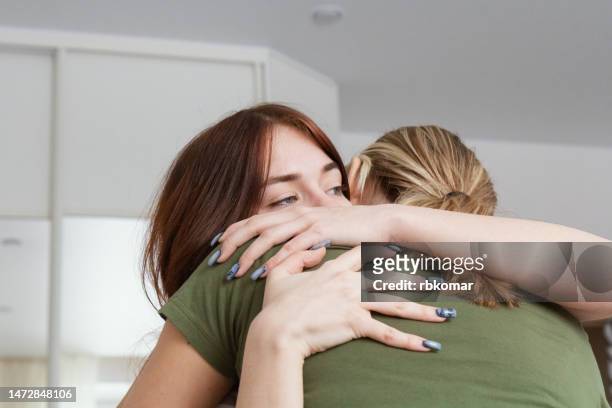 forgiveness - supporting mother and hugging daughter - apology stock pictures, royalty-free photos & images