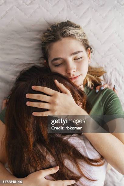 gentle hug from a friend - vergebung stock-fotos und bilder