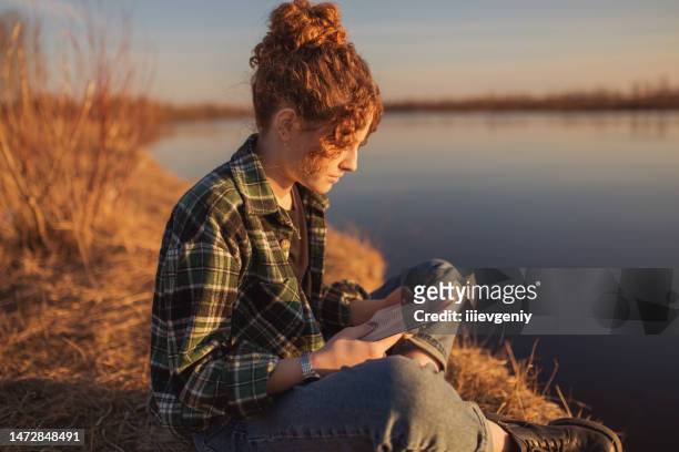 curly woman read book on sunset background. silhouette - belarus nature stock pictures, royalty-free photos & images