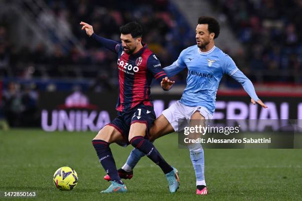 Roberto Soriano of Bologna FC is challenged by Felipe Anderson of SS Lazio during the Serie A match between Bologna FC and SS Lazio at Stadio Renato...