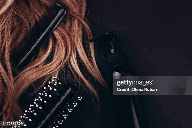 hairbrush and hair comb in long hair near styling foam. - hairdresser stock photos et images de collection