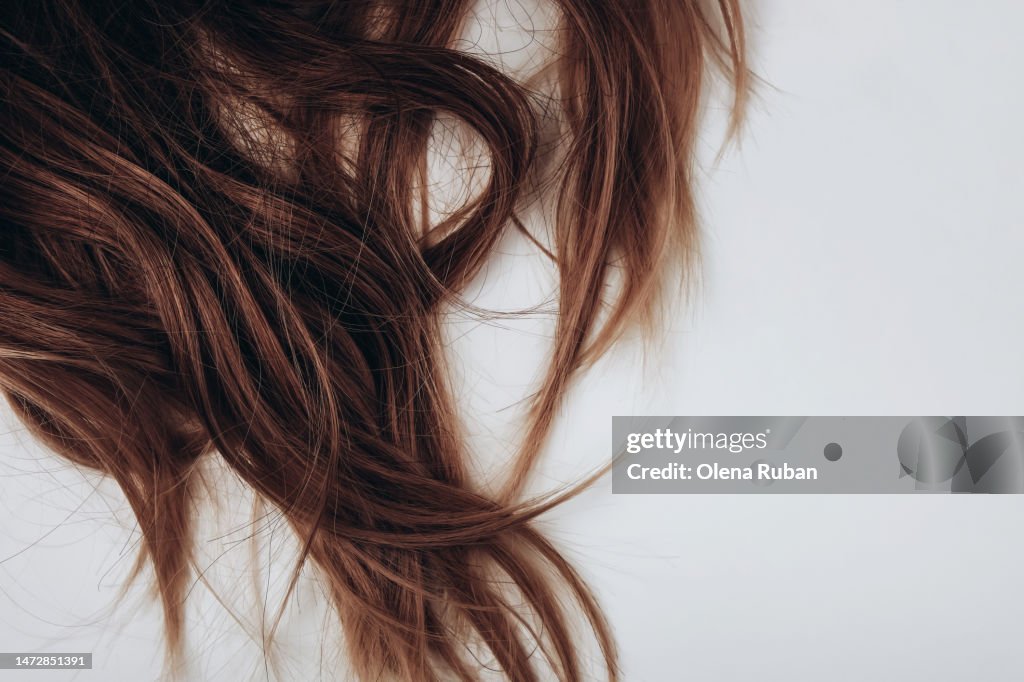 Long brown hair on light table.