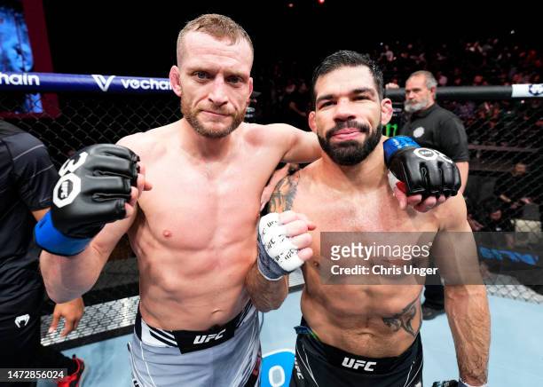 Davey Grant of England and Raphael Assuncao of Brazil pose after their bantamweight fight during the UFC Fight Night event at The Theater at Virgin...