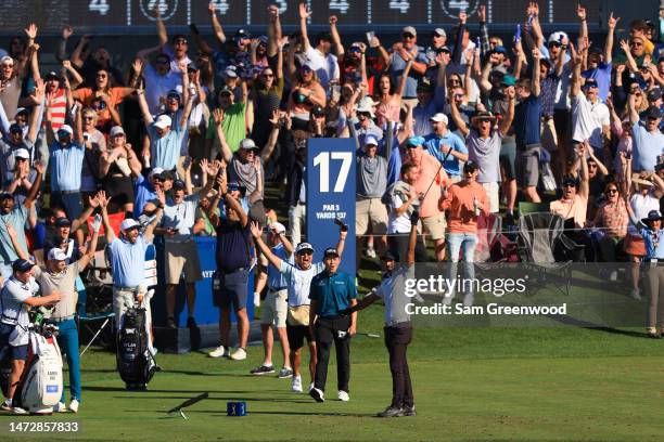 Aaron Rai of England celebrates his hole-in-one on the 17th hole during the third round of THE PLAYERS Championship on THE PLAYERS Stadium Course at...