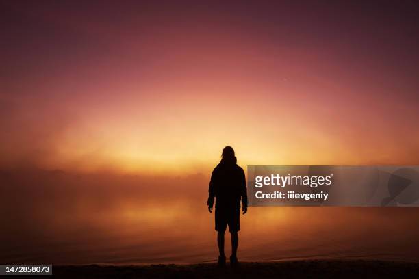 silhouette of man against background of morning sky. sunset - oman landscape stock pictures, royalty-free photos & images