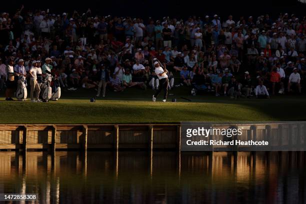 Scottie Scheffler of the United States plays his shot from the 17th tee during the third round of THE PLAYERS Championship on THE PLAYERS Stadium...