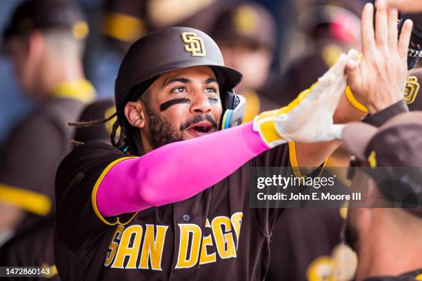 Fernando Tatis Jr. #23 of the San Diego Padres high fives teammates during the fifth inning of the Spring Training Game against the Chicago White Sox...