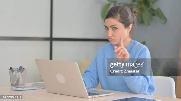 Indian Woman Shaking Head in Rejection while Working on Laptop indian woman shaking head rejection while