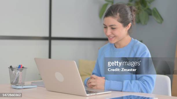 indian woman doing video chat laptop