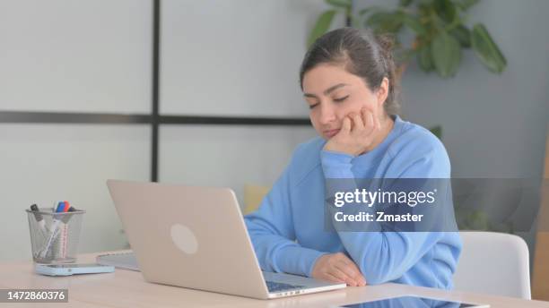 Indian Woman Sleeping while Sitting at Work indian woman sleeping while sitting at