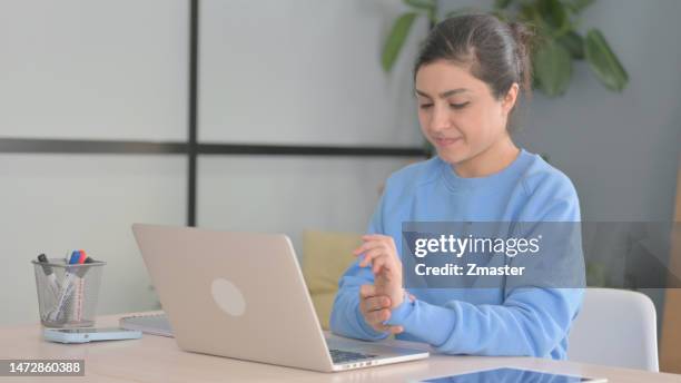 Indian Woman having Wrist Pain while using Laptop indian woman having wrist pain while