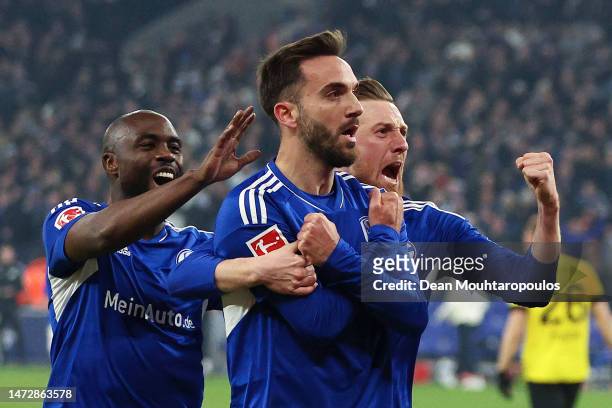 Kenan Karaman of FC Schalke 04 celebrates with teammates after scoring the team's second goal during the Bundesliga match between FC Schalke 04 and...