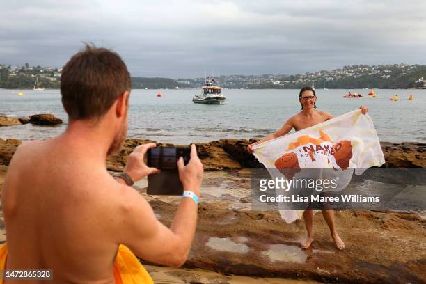 Swimmers take photos and wave sarongs after taking part in the 'Sydney Skinny' on March 12, 2023 in Sydney, Australia. The world's largest annual...