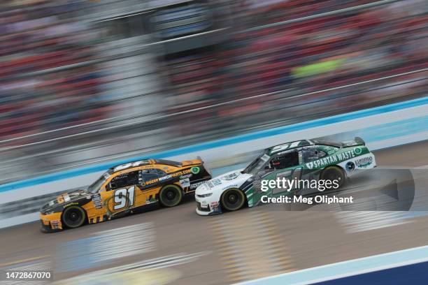 Garrett Smithley, driver of the DozerWinchParts.com Chevrolet, and Jeremy Clements, driver of the Fox Sports/Spartan Waste Chevrolet, race during the...