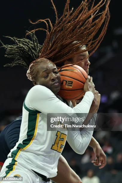 Makoye Diawara of the Norfolk State Spartans and Krislyn Marsh of the Howard Lady Bison challenge for a rebound during the second half during the...