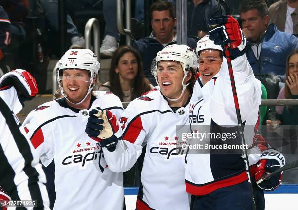 Rasmus Sandin, T.J. Oshie and Sonny Milano of the Washington Capitals celebrate Oshie's first period goal against the New York Islanders at the UBS...