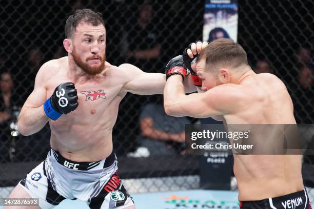 Merab Dvalishvili of Georgia punches Petr Yan of Russia in a bantamweight fight during the UFC Fight Night event at The Theater at Virgin Hotels Las...