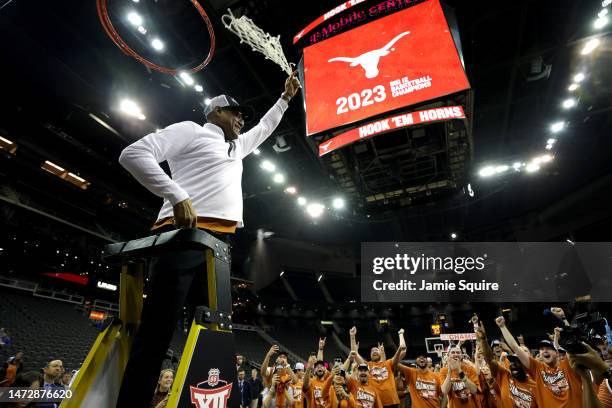 Interim head coach Rodney Terry of the Texas Longhorns celebrates by cutting down the net after defeating the Kansas Jayhawks in the Big 12...