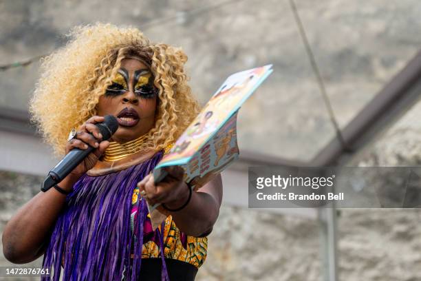 Drag Queen Beatrice Thomas, also known as Black Benatar, reads a book during a story time reading at the Cheer Up Charlies dive bar on March 11, 2023...