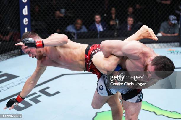 Merab Dvalishvili of Georgia attempts to take down Petr Yan of Russia in a bantamweight fight during the UFC Fight Night event at The Theater at...