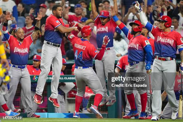 Julio Rodriguez of the Dominican Republic celebrates with teammates after scoring in the first inning against Venezuela at loanDepot park on March...