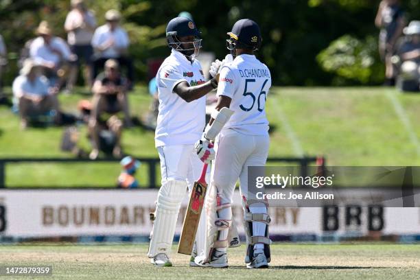 Angelo Mathews and Dinesh Chandimal of Sri Lanka shake hands after scoring a 100 run partnership during day four of the First Test match in the...