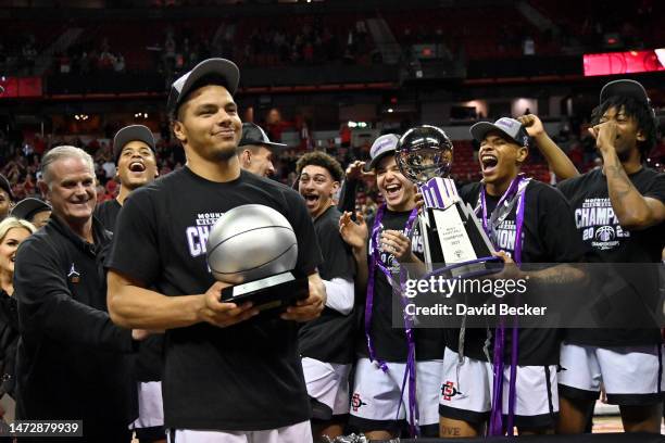 Matt Bradley of the San Diego State Aztecs celebrates with his MVP trophy after the team defeated the Utah State Aggies 62-57 in the championship...