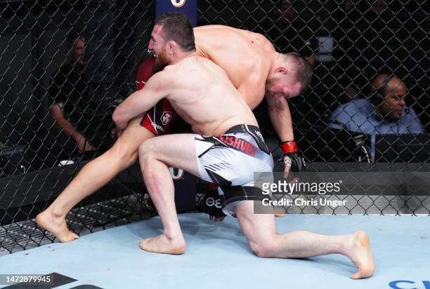 Merab Dvalishvili of Georgia attempts to take down Petr Yan of Russia in a bantamweight fight during the UFC Fight Night event at The Theater at...