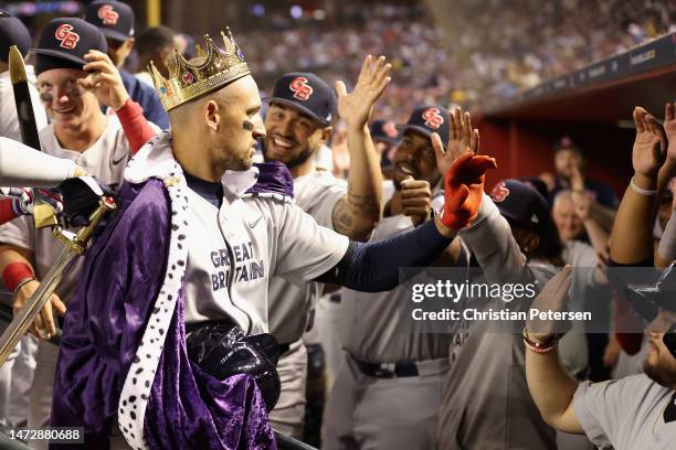 Trayce Thompson of Team Great Britain celebrates with teammates in the dugout after hitting a solo home run against Team USA during the first inning...