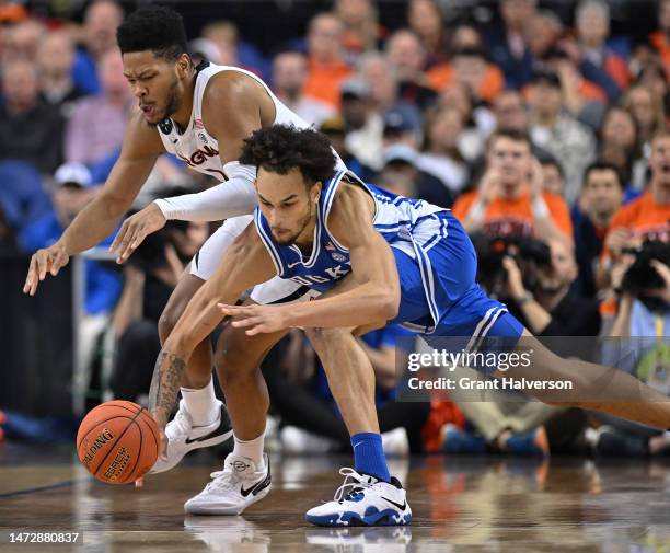 Jayden Gardner of the Virginia Cavaliers and Dereck Lively II of the Duke Blue Devils battle for a loose ball in the first half of the ACC Basketball...