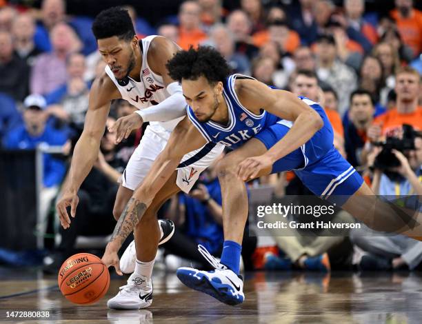 Jayden Gardner of the Virginia Cavaliers and Dereck Lively II of the Duke Blue Devils battle for a loose ball in the first half of the ACC Basketball...