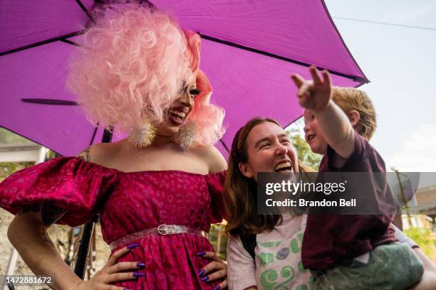 Drag Queen Brigitte Bandit laughs with supporters during a story time reading at the Cheer Up Charlies dive bar on March 11, 2023 in Austin, Texas....