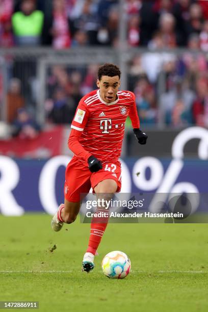 Jamal Musiala of FC Bayern München runs with the ball during the Bundesliga match between FC Bayern München and FC Augsburg at Allianz Arena on March...