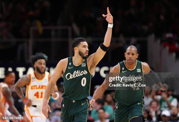 Jayson Tatum of the Boston Celtics reacts after hitting a three-point basket against the Atlanta Hawks in the final minutes of the fourth quarter at...