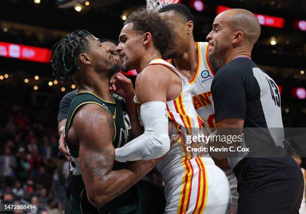 Marcus Smart of the Boston Celtics and Trae Young of the Atlanta Hawks get into an altercation as they both fall to the floor during the fourth...