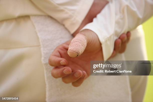 The bandaged thumb of Matthew Kuhnemann of Australia is seen during day four of the Fourth Test match in the series between India and Australia at...