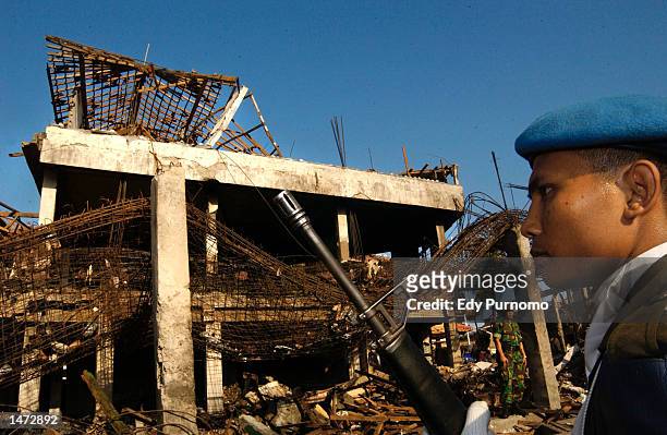 An Indonesian soldier stands guard near the bomb blast site at a Bali nightclub October 13, 2002 in Denpasar Bali, Indonesia. The blast occurred the...
